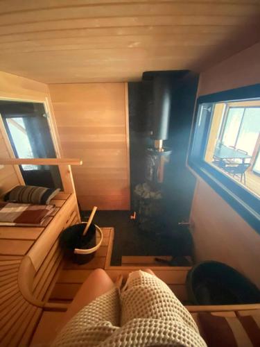 a small room with a bed and a window at Kettula Getaway - Sauna Cabin in Suomussalmi