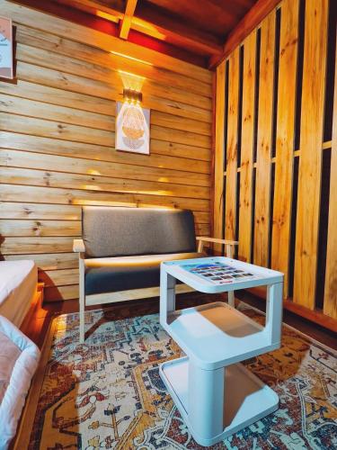 a living room with a couch and a table at miarzafa cabin house in Kejajar