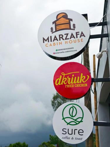 a group of signs on the side of a building at miarzafa cabin house in Kejajar