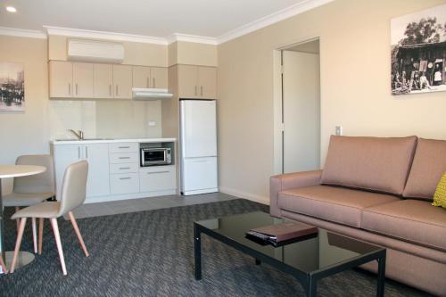 a living room with a couch and a table at Mercure Orange in Orange