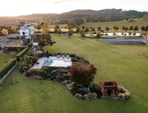 an aerial view of a large yard with a swimming pool at Linnaeus Farm, Berry - by Linnaeus Collection in Berry
