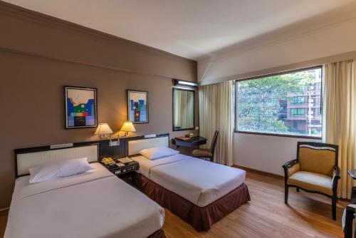 Ένα ή περισσότερα κρεβάτια σε δωμάτιο στο Chiang Mai Hill Hotel