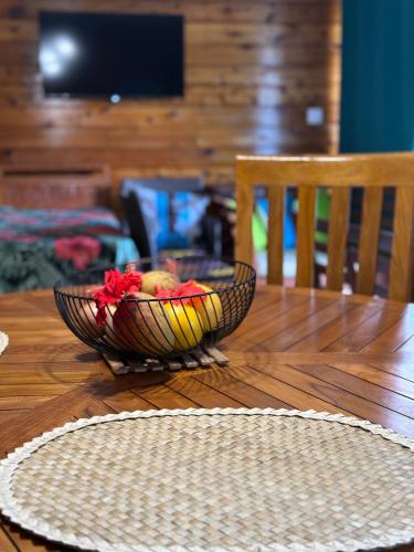 a bowl of fruit sitting on top of a wooden table at Maroe Bay Lodge in HUH