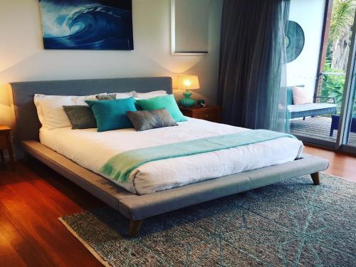 1 dormitorio con 1 cama grande con almohadas azules en Drifted Away, en Valla Beach
