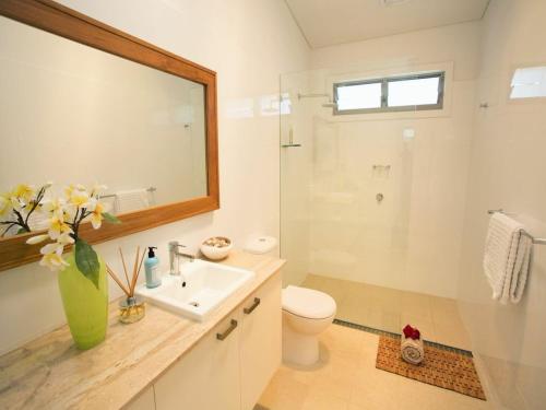 a bathroom with a sink and a toilet and a mirror at Drifted Away in Valla Beach