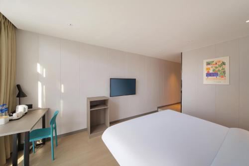 Ένα ή περισσότερα κρεβάτια σε δωμάτιο στο Elan hotel Hotel - Nanjing Zhongshan Mausoleum Scenic Area South Technology