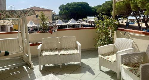 a balcony with chairs and a view of a city at La Terrazza sul Mare in Torre Grande