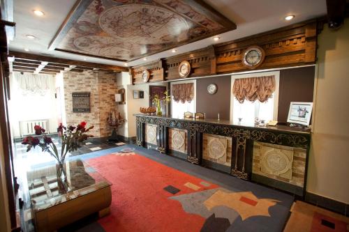 a large room with a large red rug in a building at Ostrovok in Vladivostok