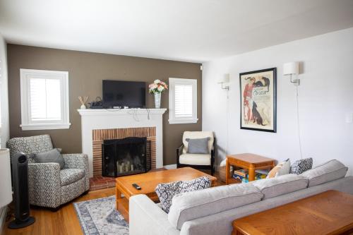 a living room with a couch and a fireplace at Historic, Family-Friendly Home in Downtown in Bakersfield