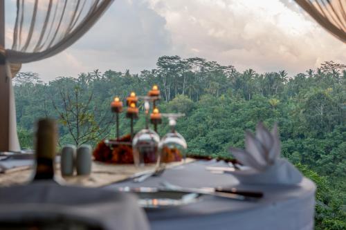 
a dining room table with flowers on it at The Payogan Villa Resort and Spa in Ubud
