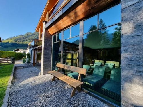 a wooden bench sitting outside of a building at Hotel Alpina in Rauris