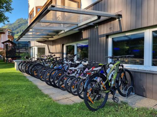 a row of bikes parked next to a building at Hotel Alpina in Rauris