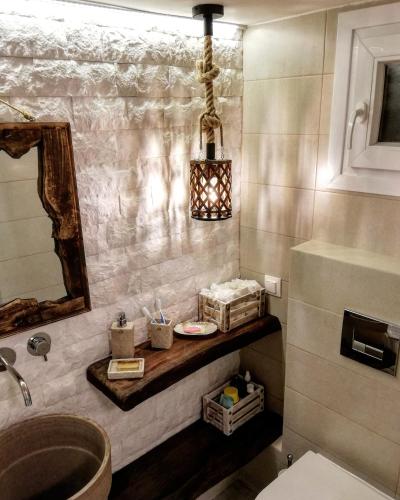 a bathroom with a sink and a mirror at Aelia House Chalkidiki in Fourka