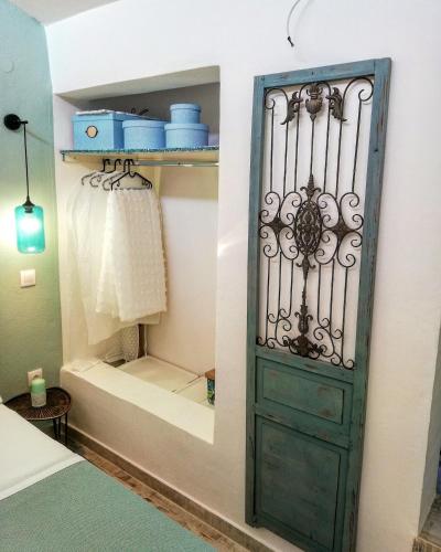 a closet with a green door in a bedroom at Aelia House Chalkidiki in Fourka