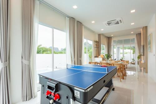 a dining room with a ping pong table in it at The Haven Krabi in Ao Nang Beach