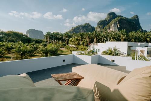 a view from the balcony of a house with mountains in the background at The Haven Krabi in Ao Nang Beach