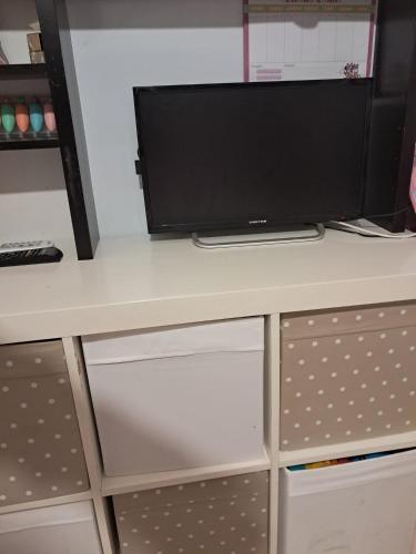 a desk with a computer monitor on top of it at Ciuri Ciuri - sea of Taormina in Letojanni