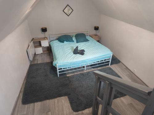 une chambre avec un lit sur lequel est assis un chat dans l'établissement superbe t3, à Cognac