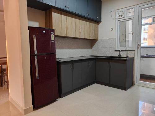 an empty kitchen with a refrigerator and a window at Astonishing 3BHK at 6-Floor for Family only in Bengaluru