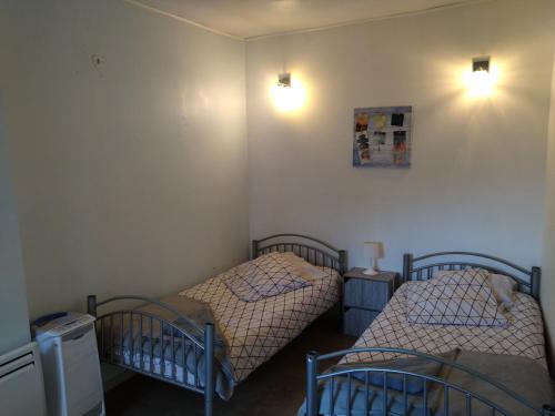 deux lits jumeaux dans une chambre avec deux lampes dans l'établissement superbe t3, à Cognac