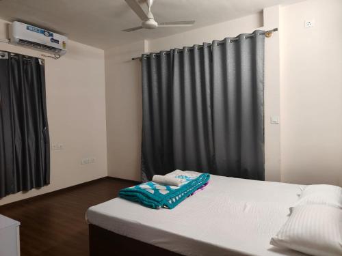 a bedroom with a bed with a black curtain at Astonishing 3BHK at 6-Floor for Family only in Bengaluru