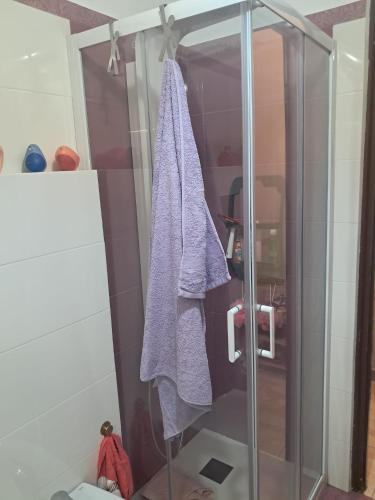 a shower with a purple towel hanging from it at Ciuri Ciuri - sea of Taormina in Letojanni