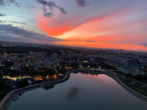 a view of a city with a river at sunset at Astonishing 3BHK at 6-Floor for Family only in Bengaluru