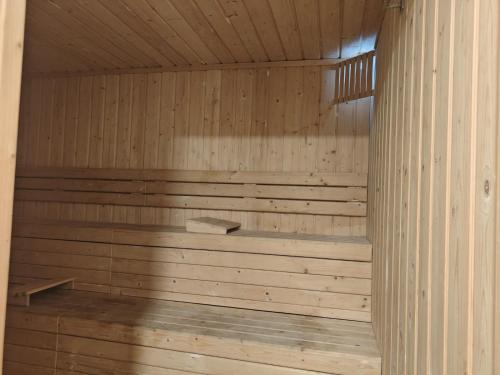 a wooden sauna with a tub in a room at Astonishing 3BHK at 6-Floor for Family only in Bengaluru