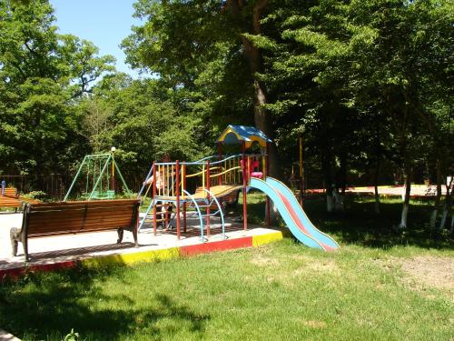a playground in a park with a slide and a bench at Hotel Bulaq in Turist