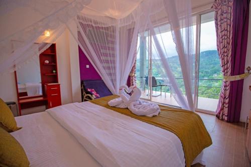 a bedroom with a bed with a towel animal on it at Ella floating view in Ella