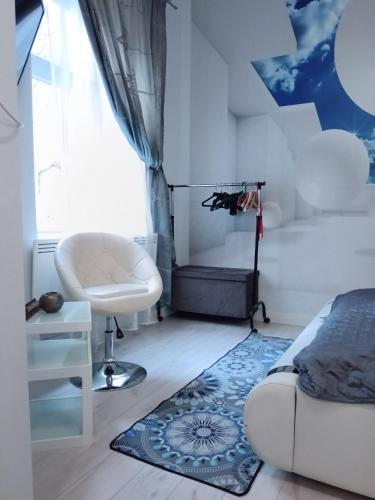 a bedroom with a bed and a chair and a rug at My little paradise in Budapest