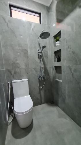 a bathroom with a toilet and a shower at Baturiti Modern Guest House with private pool in Salakan