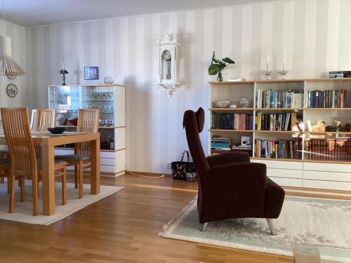 a living room with a table and a chair at Nordic Design House Lapinrinne in Rovaniemi