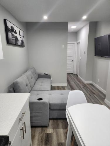 a living room with a couch and a table at lovely 2bed & 1 Bath Basement Suite for 4 guests in Calgary