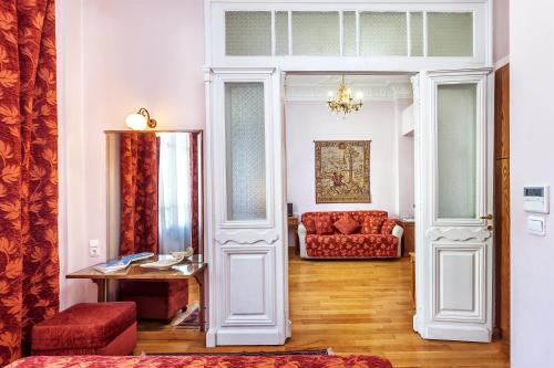 a living room with a couch and a table at Minerva Premier Hotel in Thessaloniki