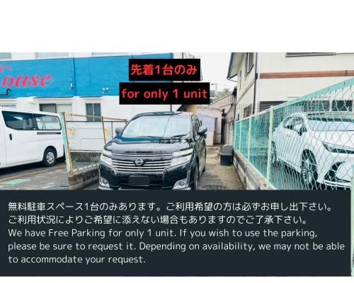 a advertisement for a car parked in a parking lot at MA House in Osaka