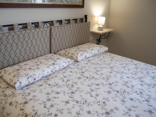 a bed with two pillows on top of it at Il Poggio degli Antichi Sapori - Residence in Paternopoli
