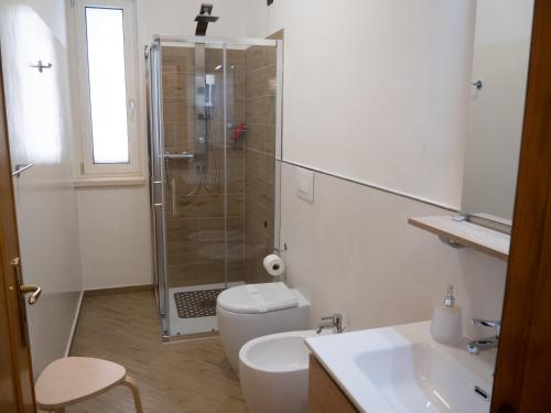 a bathroom with a shower and a toilet and a sink at Il Poggio degli Antichi Sapori - Residence in Paternopoli