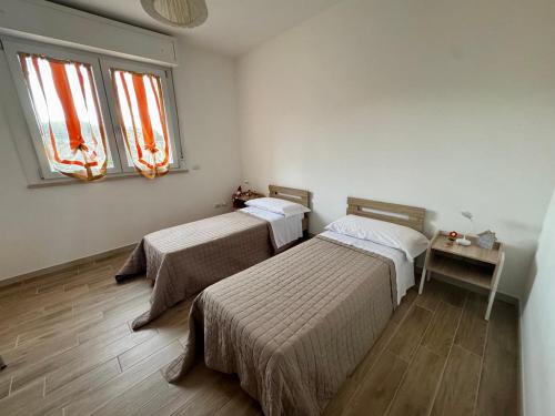 Ένα ή περισσότερα κρεβάτια σε δωμάτιο στο Casa Vacanze Ariella