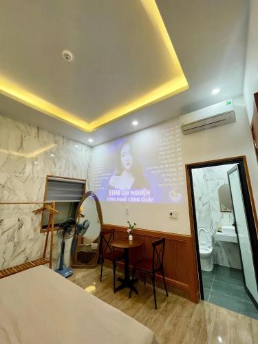 a room with a table and a large screen at BinBin Homestay Đồng Hới Quảng Bình in Dong Hoi