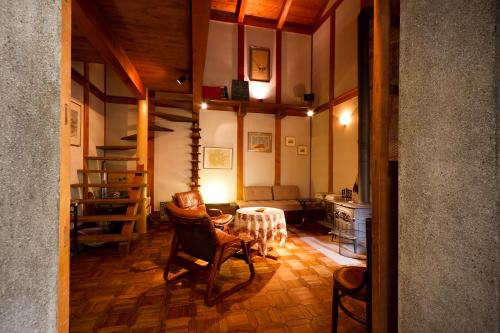 a living room with a table and chairs in it at Camellia Inn Yukitsubaki in Kanazawa