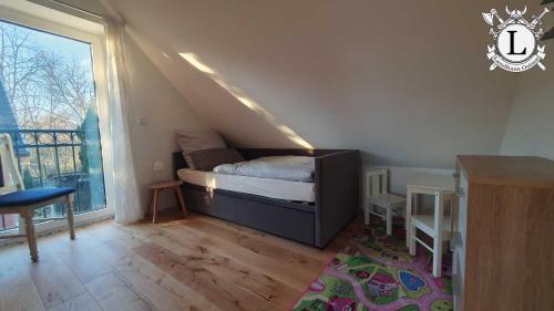 a small bedroom with a bed in a attic at Landhaus Ferien Ostsee in Sterup