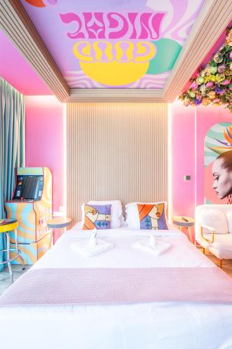 a room with a bed and a video game at Capsule Flora business bay view Burj Khalifa-pool table-game arcade-Projector-Playstation 5 in Dubai