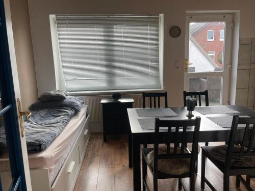 a bedroom with a bed and a table and chairs at Fewo Itzehoe in Itzehoe