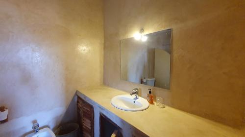 a bathroom with a sink and a mirror at Kirepwe Ecco Camp Watamu in Watamu