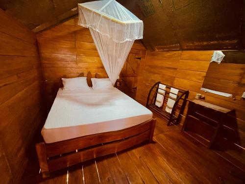 a bedroom with a bed in a wooden cabin at Green land tree house sigiriya in Sigiriya