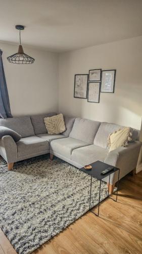 a living room with a couch and a rug at Welcome Home in Royston