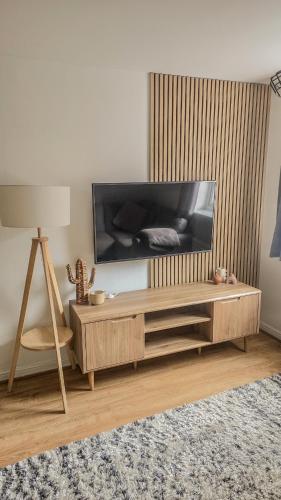 a living room with a large flat screen tv at Welcome Home in Royston