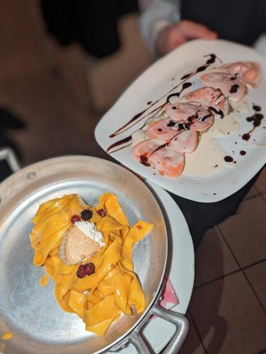 two plates of food sitting on a table at Hotel il Rifugio del Lupo scanno in Scanno