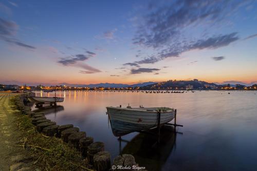 two boats sitting in the water at sunset at Casa Azzurra in Messina